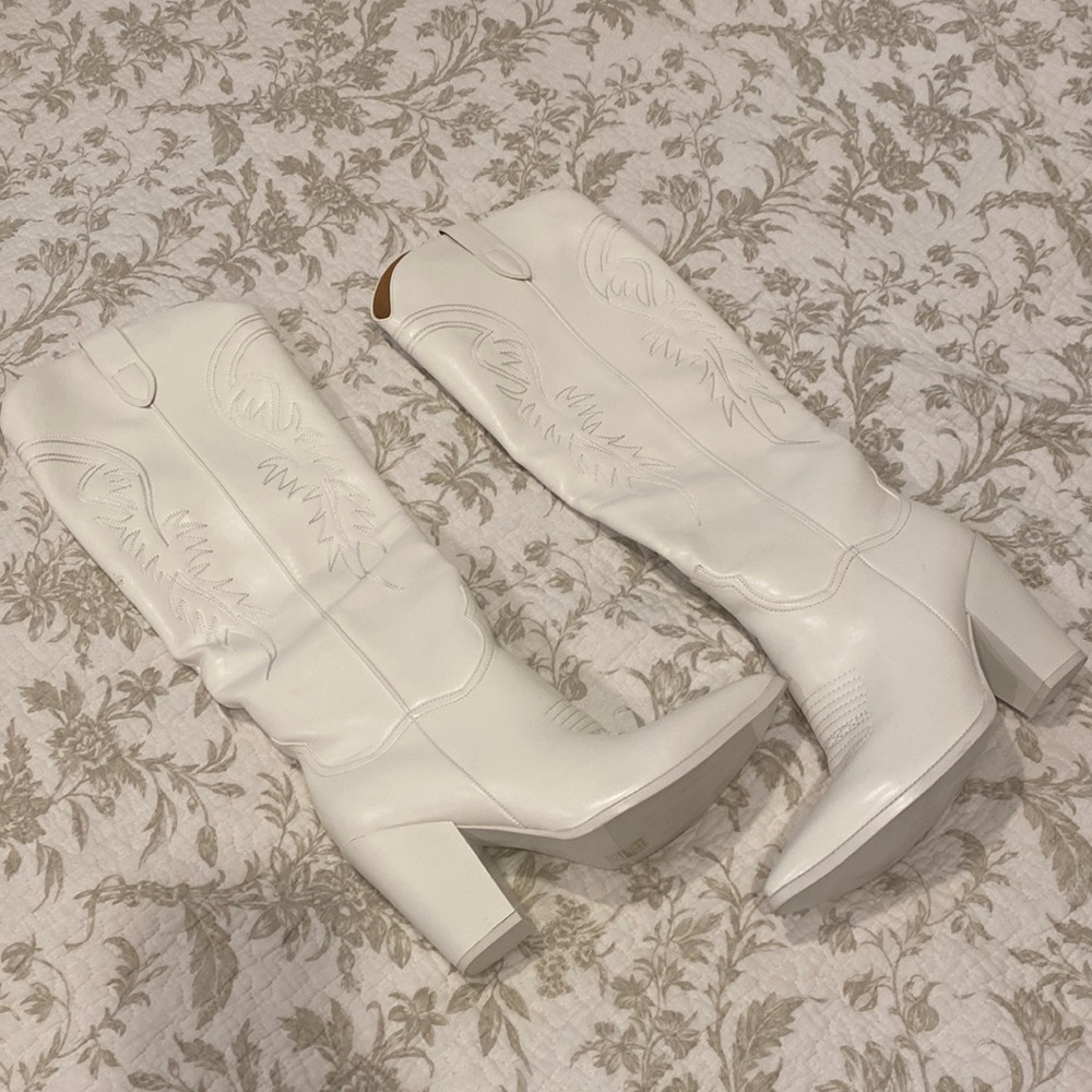 Tall white cowboy boots.